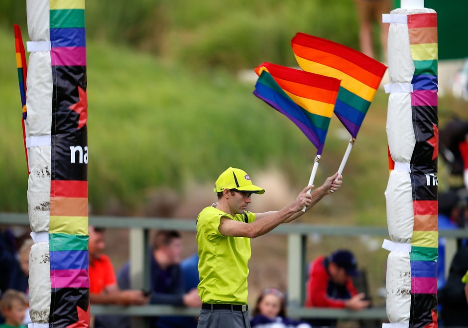 AFL 2015 NAB Challenge - Sydney v Fremantle The goal umpire waves rainbow flags during NAB Challenge match earlier this year - ${keywords}